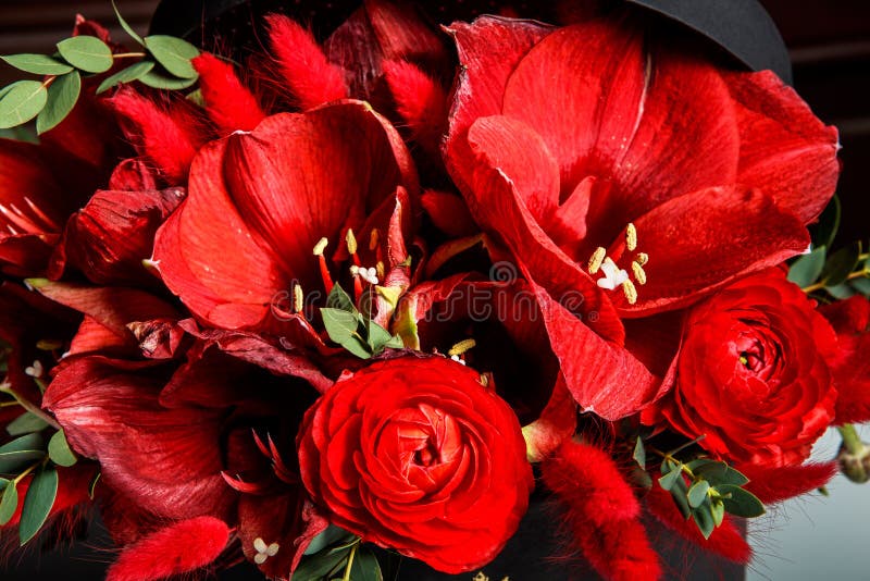Macro view of exquisite bouquet made from red lilies, roses, and fresh greenery stock photography Macro view of exquisite bouquet made from red lilies, roses, and fresh greenery stock photography