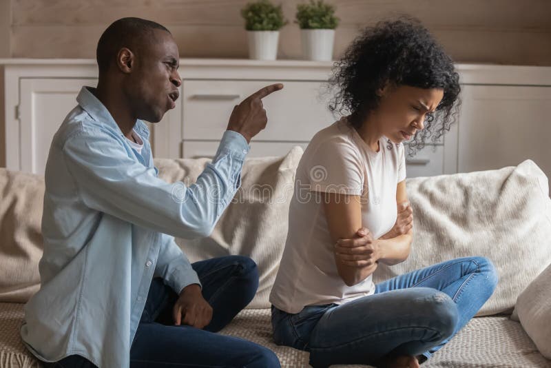 Mad african American man scold blame offended wife stock photo Mad african American man scold blame offended wife stock photo