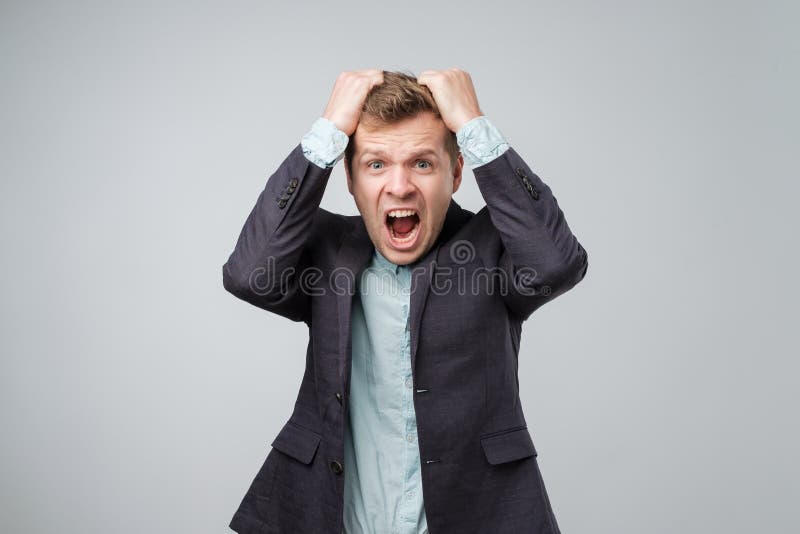 Mad business man or employee screaming, being upset about situation, outcome of his case, isolated white background. Negative human emotions, facial expressions