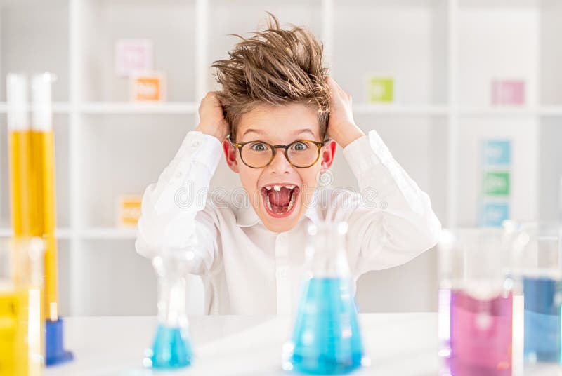 Crazy little chemist tearing hair and yelling while conducting experiment in school laboratory during studies. Crazy little chemist tearing hair and yelling while conducting experiment in school laboratory during studies