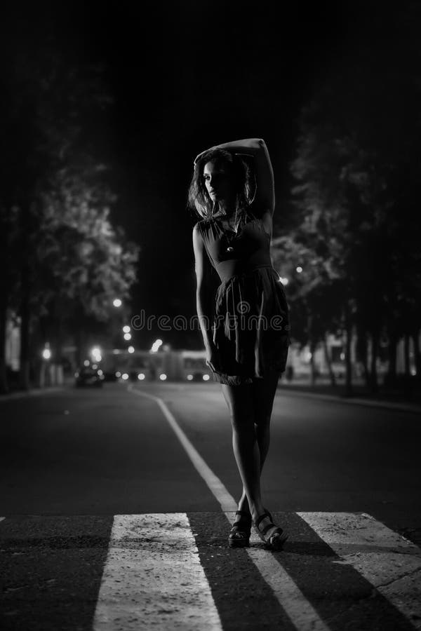 Art fashion portrait of young woman on crosswalk. Black and white. Art fashion portrait of young woman on crosswalk. Black and white