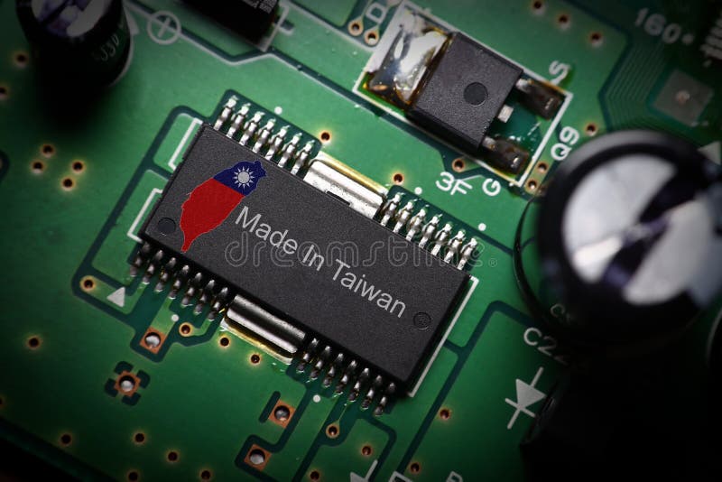 Outline of the Taiwan island &#x28;with a superimposed Taiwanese flag&#x29; and the `Made In Taiwan` text printed on the top side of an integrated circuit &#x28;IC&#x29;. In the background is the green printed circuit board PCB to which the IC is mounted on. Also visible are electronic components on the PCB. Outline of the Taiwan island &#x28;with a superimposed Taiwanese flag&#x29; and the `Made In Taiwan` text printed on the top side of an integrated circuit &#x28;IC&#x29;. In the background is the green printed circuit board PCB to which the IC is mounted on. Also visible are electronic components on the PCB