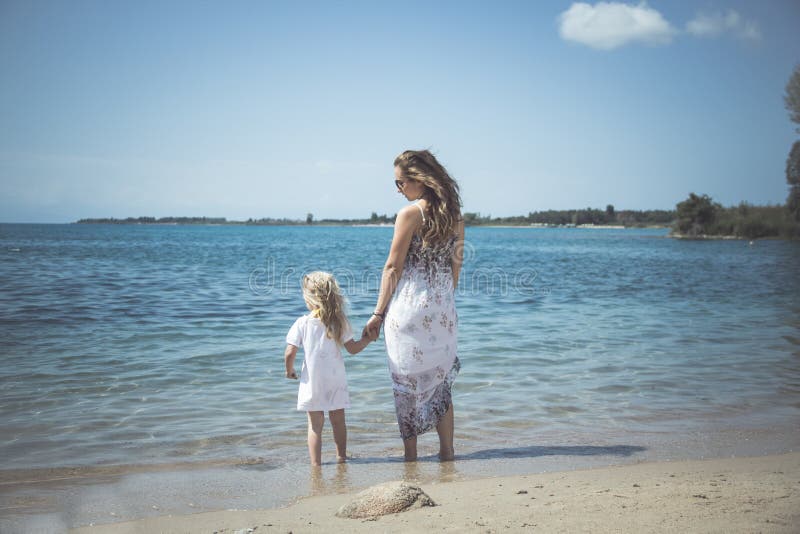 Madre con la ragazza del bambino dal mare Ritratto di tramonto esterno Estate Donna con la ragazza fotografia stock libera da diritti Madre con la ragazza del bambino dal mare Ritratto di tramonto esterno Estate Donna con la ragazza fotografia stock libera da diritti