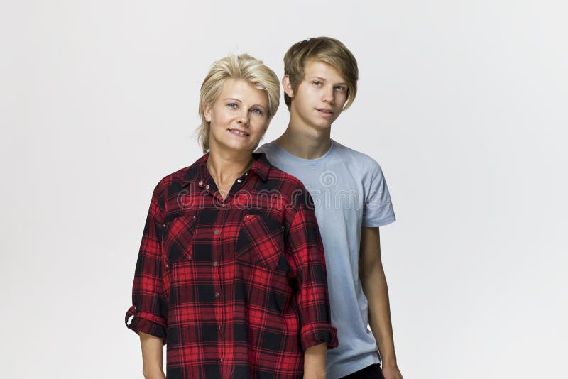 Madre e hijo felices y sonrientes Retrato cariñoso de la familia contra el fondo blanco imagen de archivo Madre e hijo felices y sonrientes Retrato cariñoso de la familia contra el fondo blanco imagen de archivo