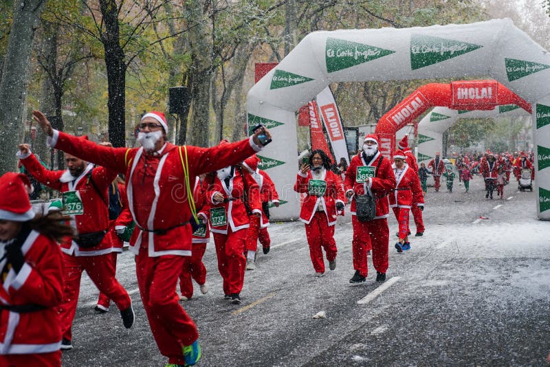 Madrid, Spain, December 8th 2019: Crowd of Santa Clauses running in street