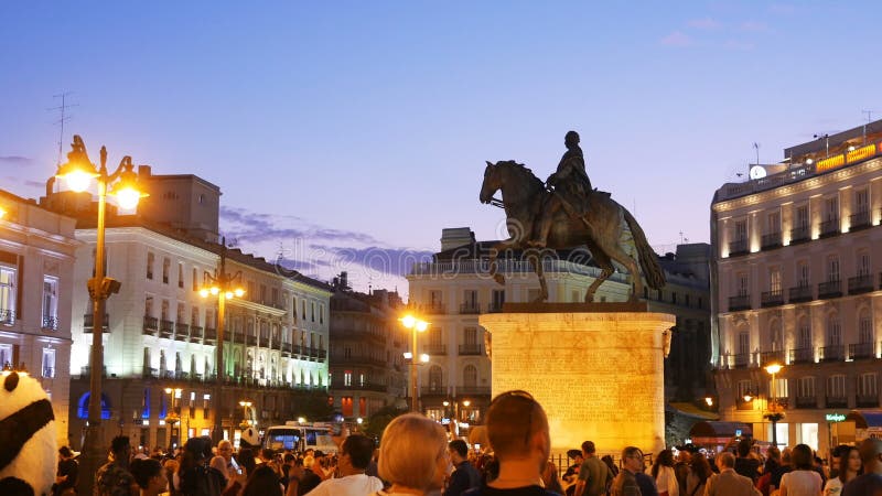 Madrid, Spain - Oct 2019: People walking and having fun in Puerta del Sol Square Sun Gate at dusk