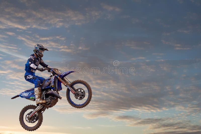 Motocross Rider Performing High Jump At Sunset Stock Photo - Download Image  Now - Motocross, Motorcycle, Jumping - iStock