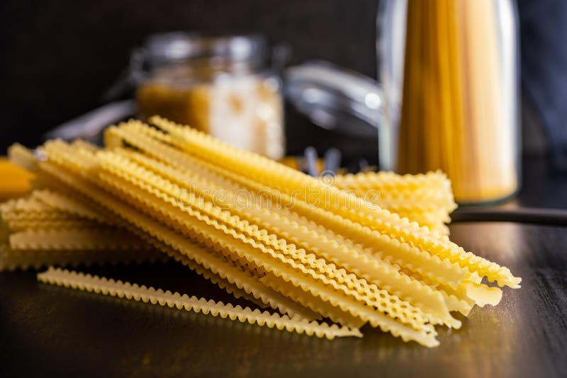 Mafaldine pasta. Uncooked italian pasta on black table royalty free stock photography