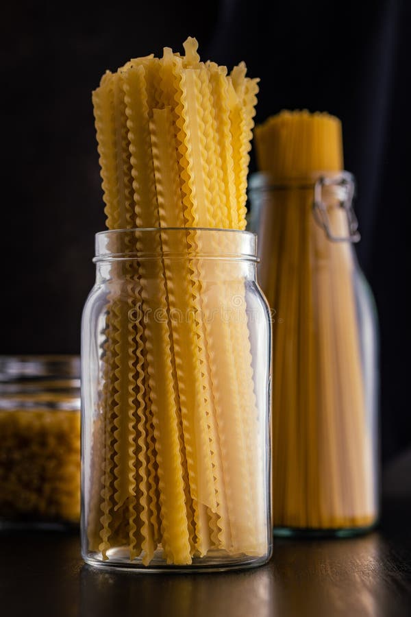 Mafaldine pasta. Uncooked italian pasta in jar royalty free stock photo