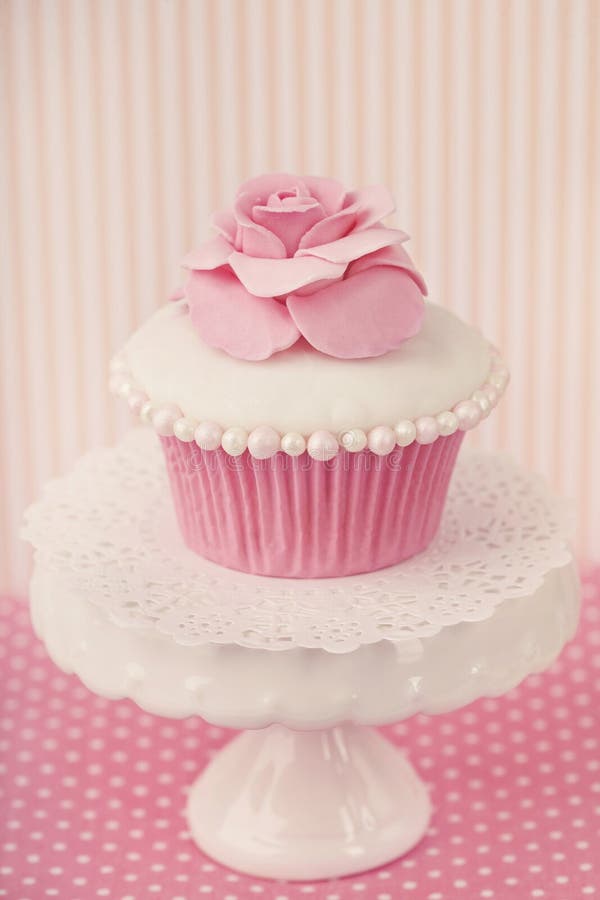 Cupcake with rose flower on a stand. Cupcake with rose flower on a stand