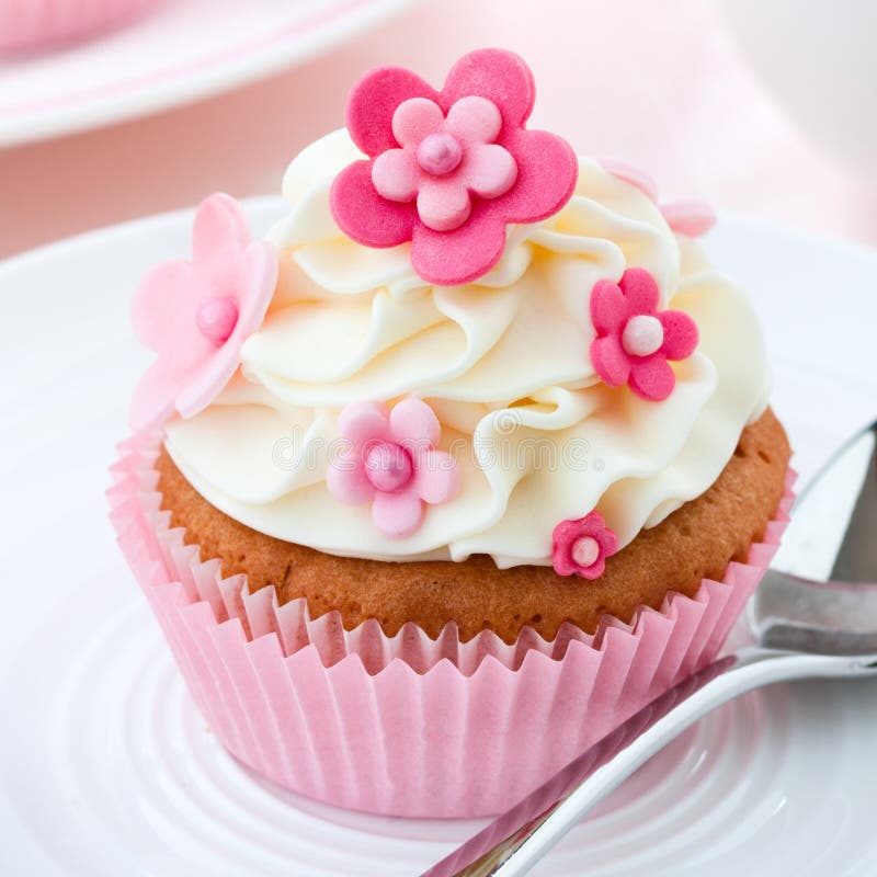 Cupcake decorated with pink fondant flowers. Cupcake decorated with pink fondant flowers