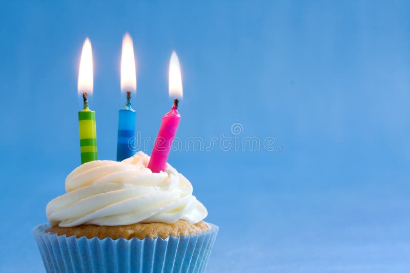 Cupcake decorated with brightly colored candles. Cupcake decorated with brightly colored candles