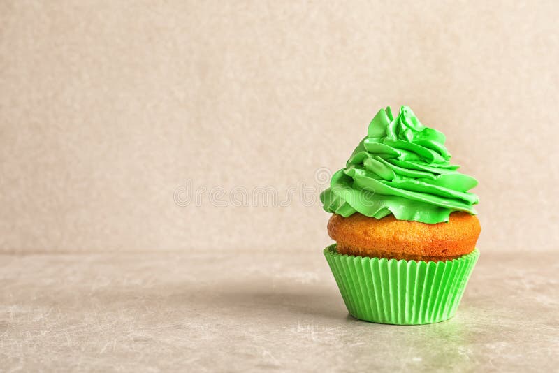 Delicious birthday cupcake with cream on light background. Delicious birthday cupcake with cream on light background