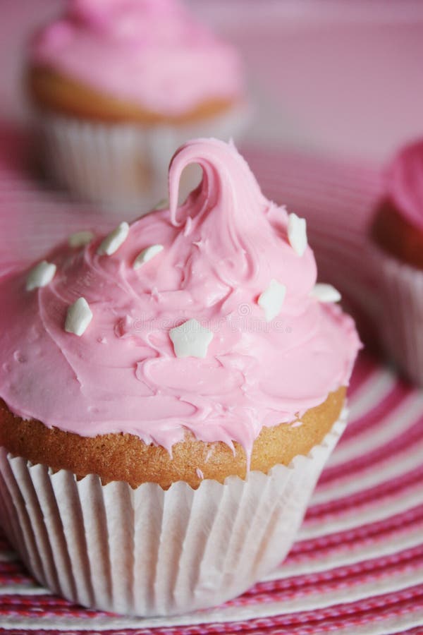 Delicious pinky cupcake on a pink background. Delicious pinky cupcake on a pink background