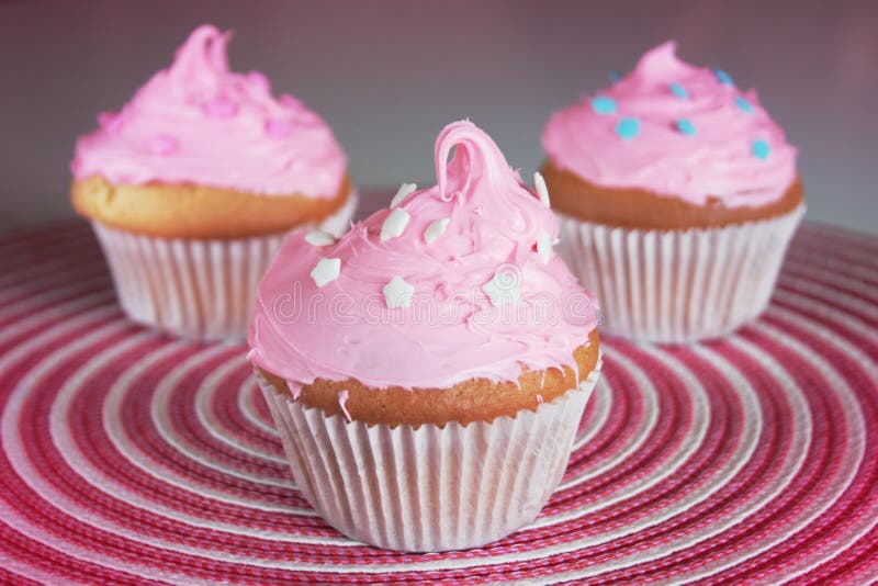 Delicious pinky cupcake on a pink background. Delicious pinky cupcake on a pink background