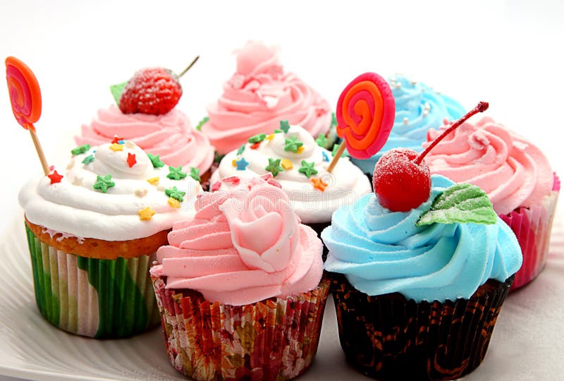 Close-up of colorful cupcakes with pink frosting and sprinkling on white background. Close-up of colorful cupcakes with pink frosting and sprinkling on white background