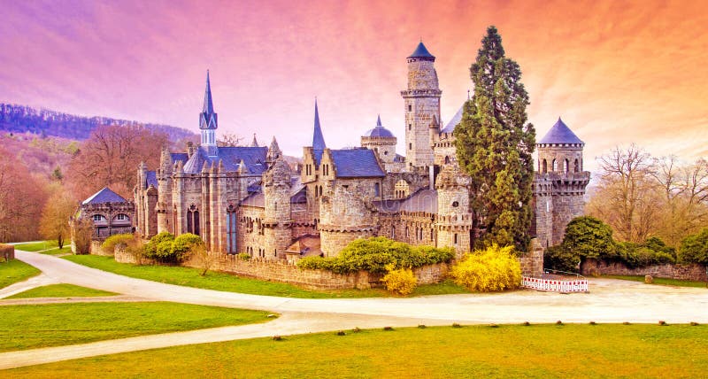 Magical landscape with medieval Lion castle or Lowenburg in Wilhelmshoehe Castle Park in Kassel, Germany, Europe at dawn.