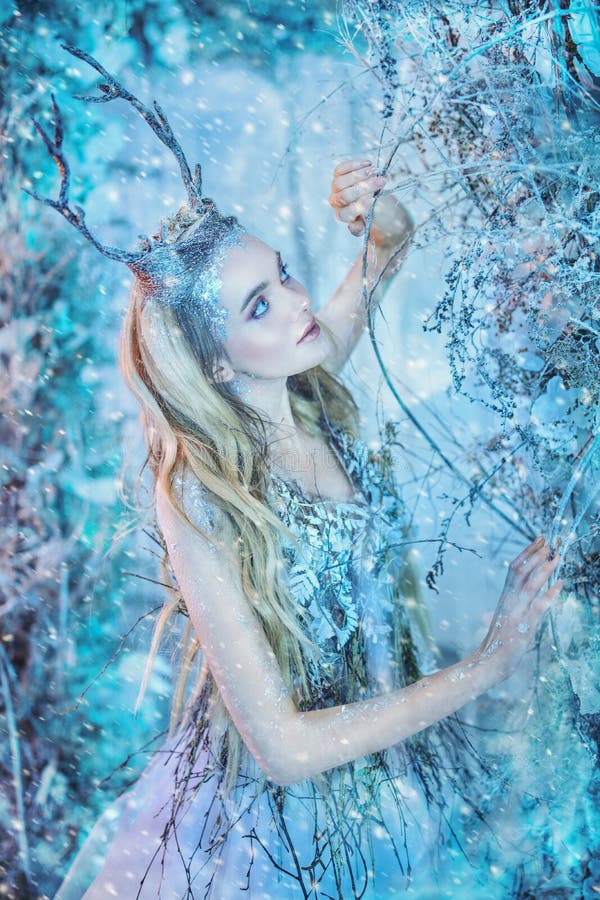 Winter fairytale. Portrait of a beautiful forest nymph in a magical winter forest. Fantasy world. Christmas tales