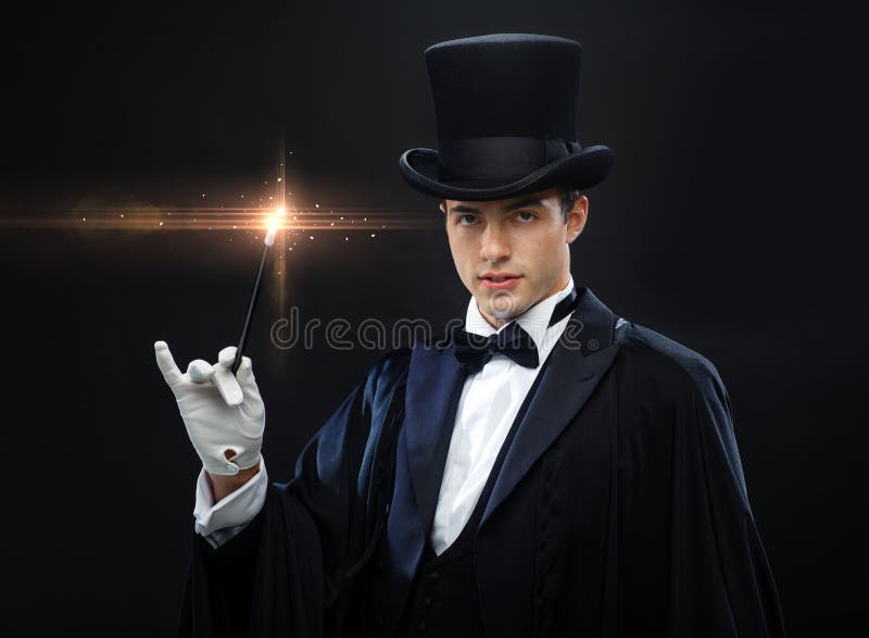 Magician in top hat with magic wand showing trick stock image Magician in top hat with magic wand showing trick stock image