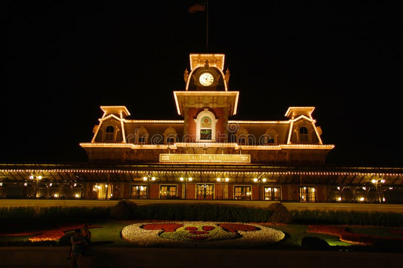 Main Entrance of Disney's Magic Kingom in Orlando where all the characters meet and greet the first visitors in the morning, shot at night after closing hours, all lit up. Main Entrance of Disney's Magic Kingom in Orlando where all the characters meet and greet the first visitors in the morning, shot at night after closing hours, all lit up