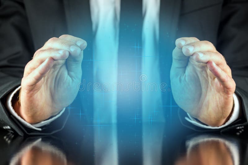 Magician with a crystal blue glow holding his hands protectively above it to feel the energy as he foretells or predicts the future conceptual of a fortune teller. Magician with a crystal blue glow holding his hands protectively above it to feel the energy as he foretells or predicts the future conceptual of a fortune teller.