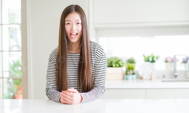 Maglione d'uso delle bande della bella donna asiatica che attacca lingua fuori soddisfatta dell'espressione divertente fotografie stock libere da diritti