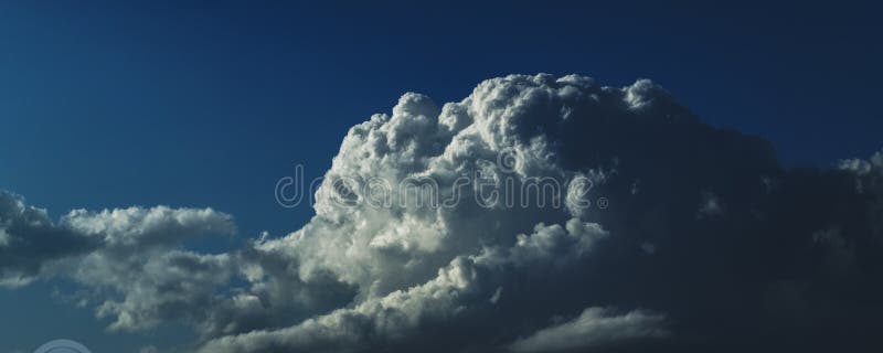 Magnificent white Cumulonimbus cloud in blue sky. Australia.