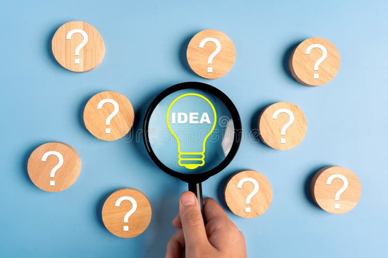 Magnifier focus light bulb illuminated and question icon, idea concept stock photography