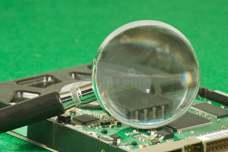 Magnifier on microchip background stock photo