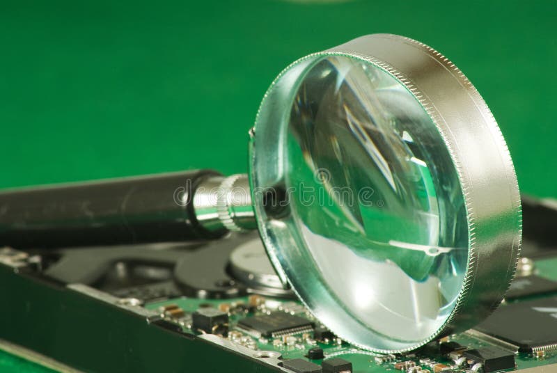 Magnifier on microchip background royalty free stock image