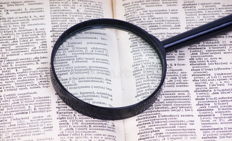 Magnifying Glass On Book.