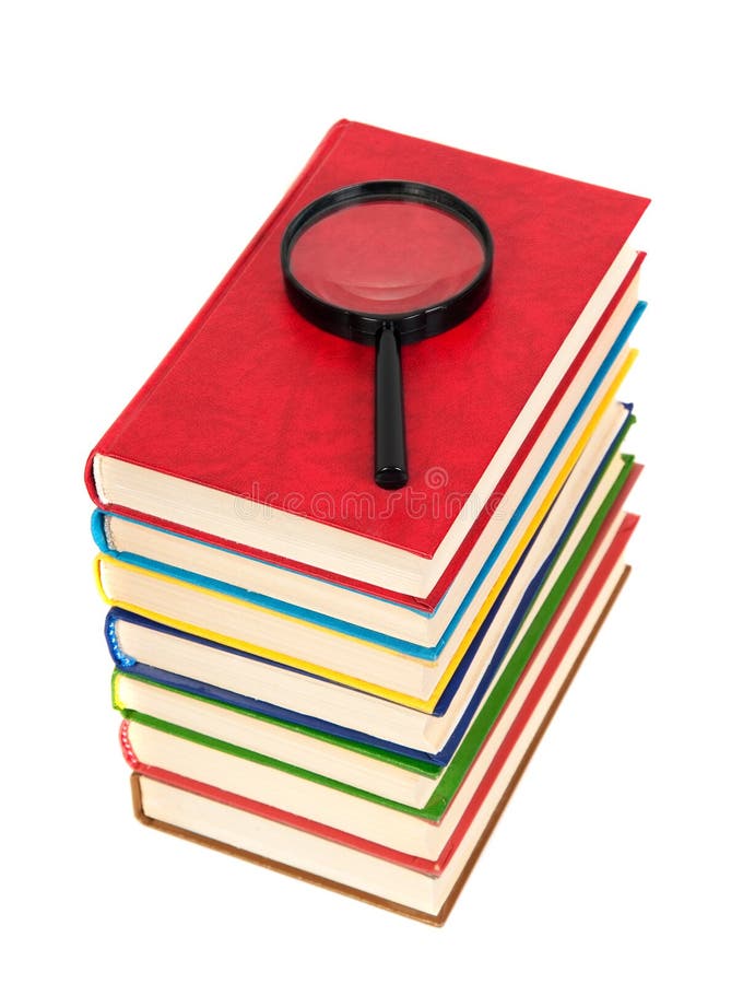 Magnifying glass and books royalty free stock image