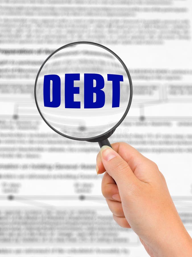 Magnifying glass in hand and word Debt royalty free stock photos