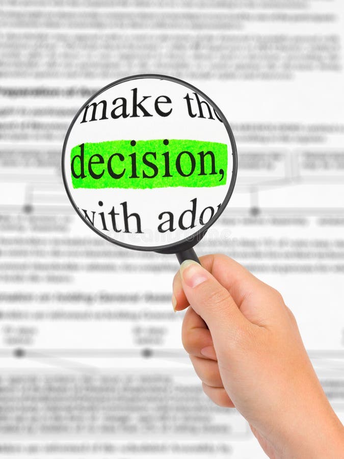 Magnifying glass in hand and word Decision royalty free stock photos