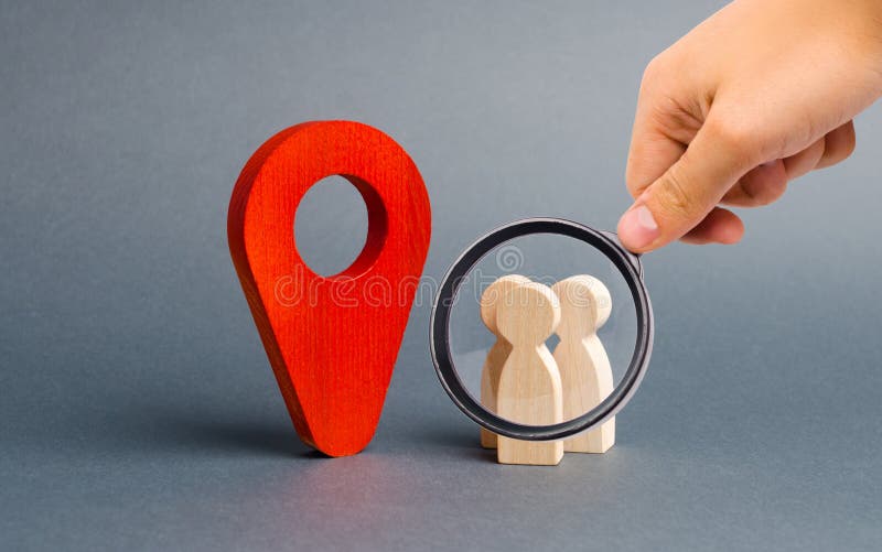 Magnifying glass is looking at people are standing near the location marker. Concept of navigation and venue. Tourism and travel.