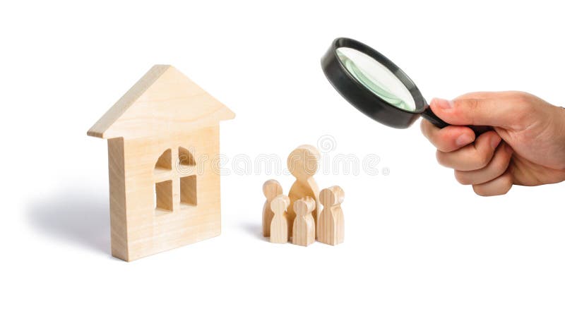Magnifying glass is looking at the young family with children is standing near a wooden house. concept of a strong family, royalty free stock image Magnifying glass is looking at the young family with children is standing near a wooden house. concept of a strong family, royalty free stock image