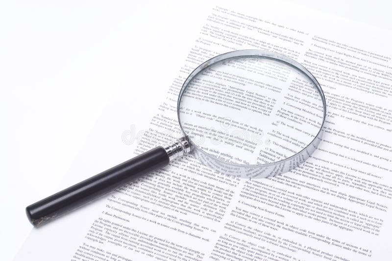 Magnifying glass lying on a legal contract