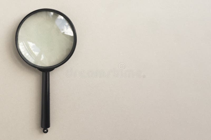 Magnifying glass over pale beige background. Magnifier as concept of finding answers stock images