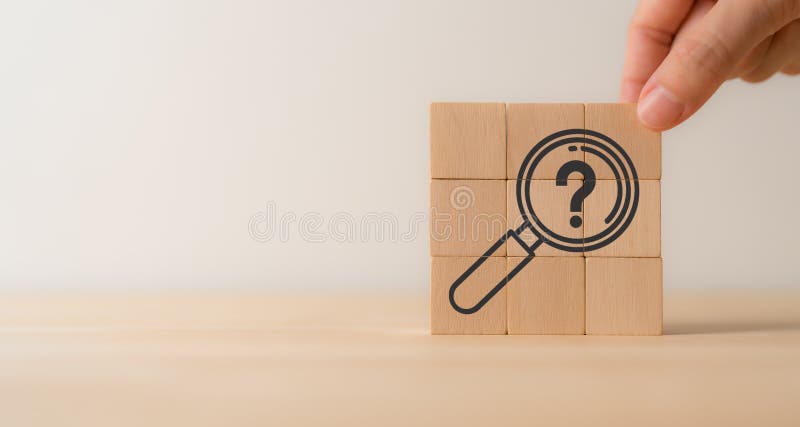 Magnifying glass and question mark icon on wooden cube blocks. Question mark, problems and root cause analysis. royalty free stock images