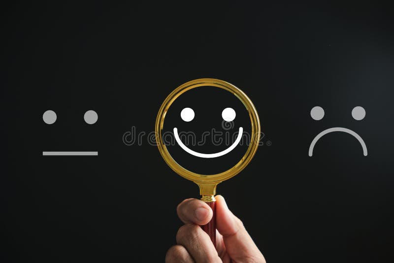 Magnifying glass reveals smiley face, finding happiness amid sadness on black stock photography