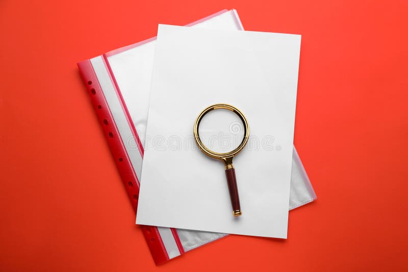 Magnifying Glass, Sheet of Paper and Folder on Red Background, Top View