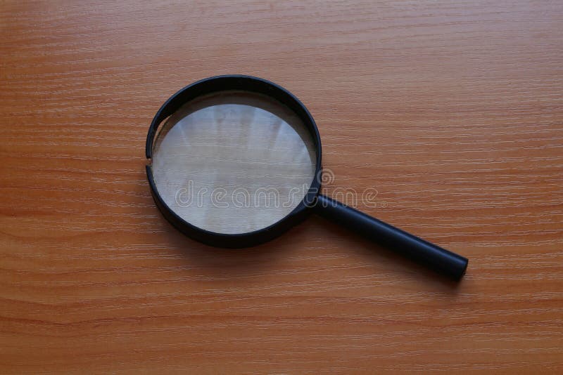 Magnifying glass on table stock photo. Image of magnifying 130070620