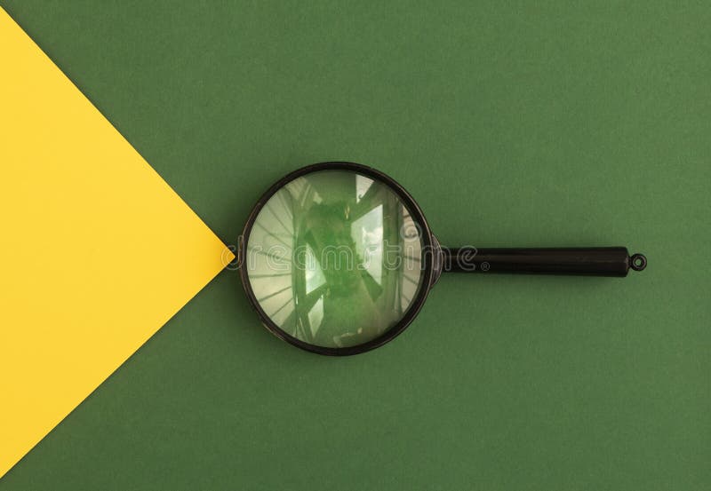 Magnifying lens over green background with yellow light beam. Search tool. Concept of finding answers royalty free stock photography