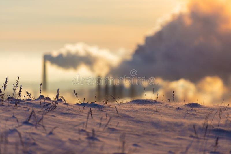 Magnitogorsk. Emissions of air pollutants. Grass under the snow on the background of an industrial plant stock photography Magnitogorsk. Emissions of air pollutants. Grass under the snow on the background of an industrial plant stock photography