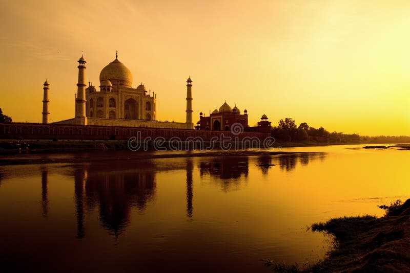 Taj Mahal at sunset reflected in the Yamuna river. Taj Mahal at sunset reflected in the Yamuna river.