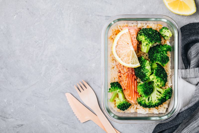 Meal prep lunch box containers with grilled salmon fish, rice, green broccoli. Meal prep lunch box containers with grilled salmon fish, rice, green broccoli