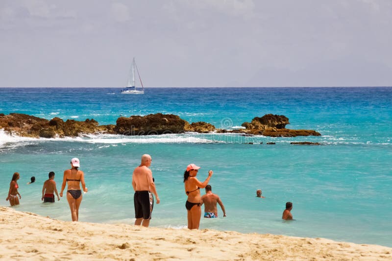 People enjoying the sun, sand and water of Maho Bay beach near Princess Juliana International Airport in St. Maarten in the Netherlands Antilles, or Dutch West Indies. People enjoying the sun, sand and water of Maho Bay beach near Princess Juliana International Airport in St. Maarten in the Netherlands Antilles, or Dutch West Indies.