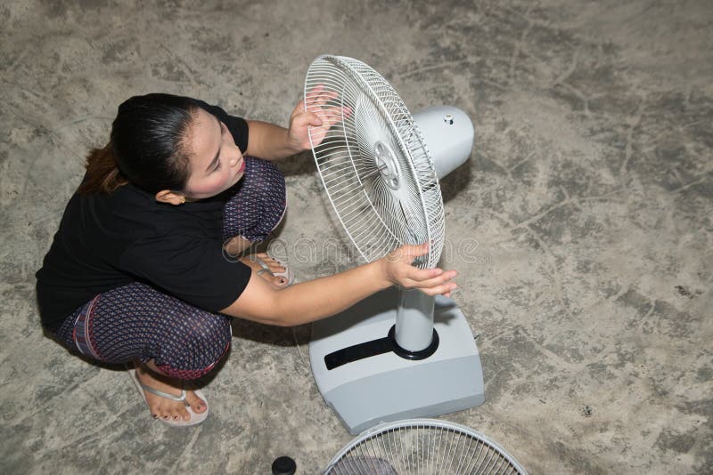 The Maidservant is Assembling and Installing an Electric Fan after