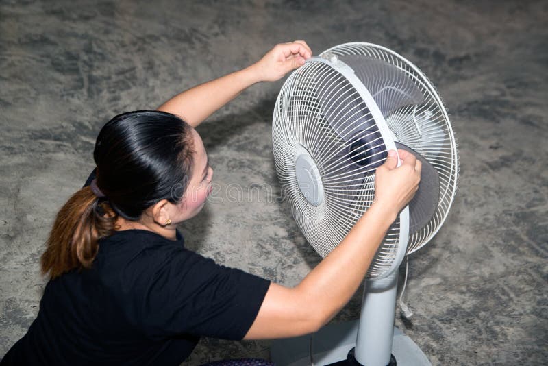 The Maidservant is Assembling and Installing an Electric Fan after
