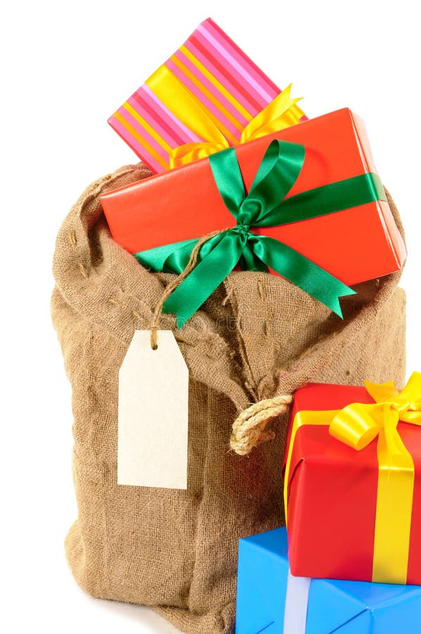 Mail bag or stocking filled with Christmas gifts isolated on white background. Santa sack full with pile of Christmas gifts isolated on white background stock photo Mail bag or stocking filled with Christmas gifts isolated on white background. Santa sack full with pile of Christmas gifts isolated on white background stock photo
